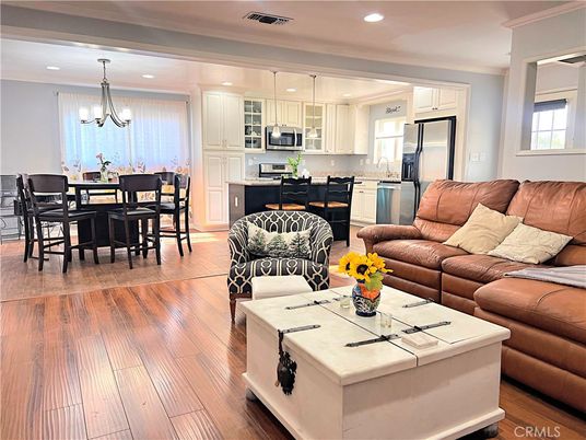 Chandelier, Dining room, Interior, Kitchen, Living room, Pendant Lights, Recessed Lighting, Stainless Steel Appliances, Wood Texture Flooring