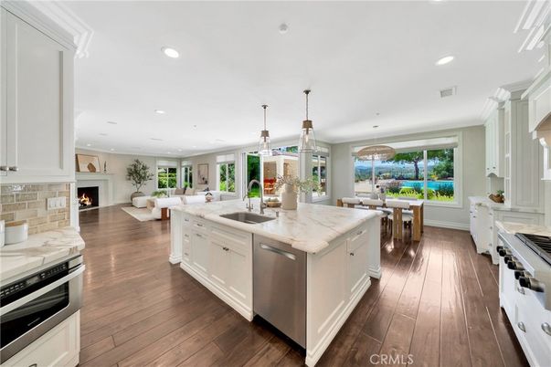 Dining room, Fireplace, Interior, Kitchen, Living room, Pendant Lights, Recessed Lighting, Stainless Steel Appliances, Wood Texture Flooring