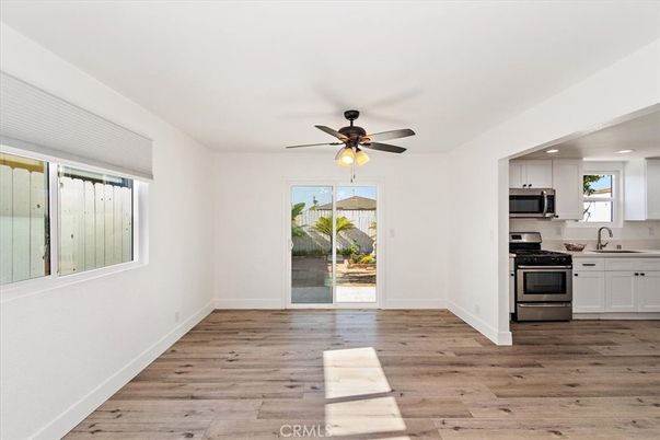 Empty room, Interior, Kitchen, Recessed Lighting, Stainless Steel Appliances, Wood Texture Flooring