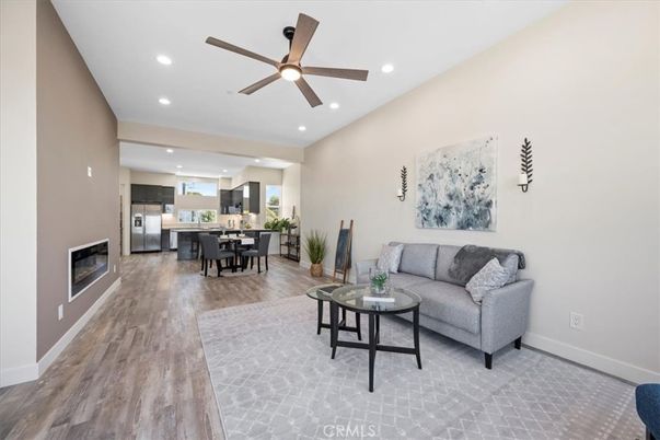 Dining room, Fireplace, Interior, Kitchen, Living room, Recessed Lighting, Stainless Steel Appliances, Wood Texture Flooring