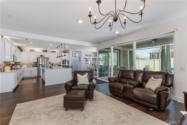 Chandelier, Interior, Kitchen, Living room, Pendant Lights, Recessed Lighting, Stainless Steel Appliances, Wood Texture Flooring