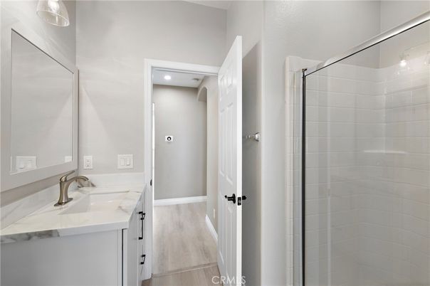 Bathroom, Dual Sink Vanities, Glass Shower, Interior, Recessed Lighting, Wood Texture Flooring