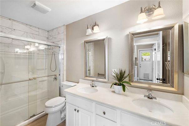 Bathroom, Dual Sink Vanities, Glass Shower, Interior, Marble Walls, Wood Texture Flooring