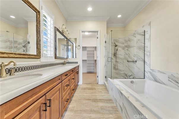 Bathroom, Dual Sink Vanities, Glass Shower, Interior, Marble Walls, Recessed Lighting, Wood Texture Flooring