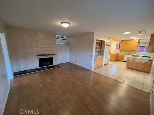 Empty room, Fireplace, Interior, Kitchen, Tile Countertops, Wood Texture Flooring