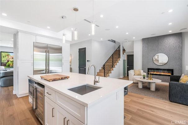 Fireplace, Interior, Kitchen, Living room, Pendant Lights, Recessed Lighting, Stainless Steel Appliances, Wood Texture Flooring