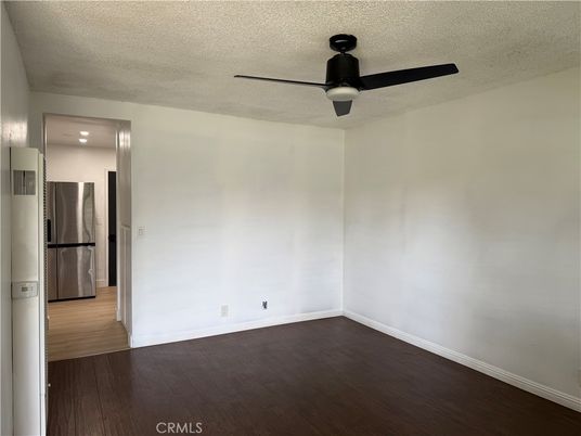 Empty room, Interior, Kitchen, Recessed Lighting, Stainless Steel Appliances, Wood Texture Flooring
