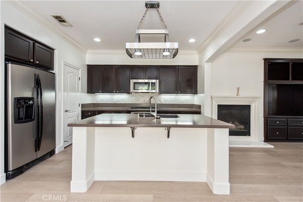 Fireplace, Interior, Kitchen, Pendant Lights, Recessed Lighting, Stainless Steel Appliances, Wood Texture Flooring