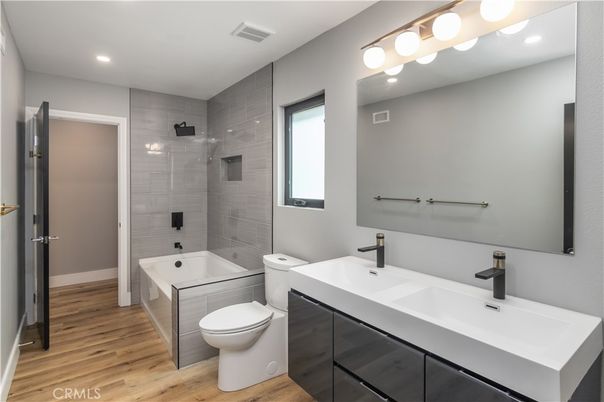 Bathroom, Dual Sink Vanities, Glass Shower, Interior, Recessed Lighting, Wood Texture Flooring