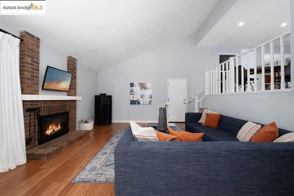 Fireplace, Interior, Living room, Recessed Lighting, Stone Walls, Wood Texture Flooring