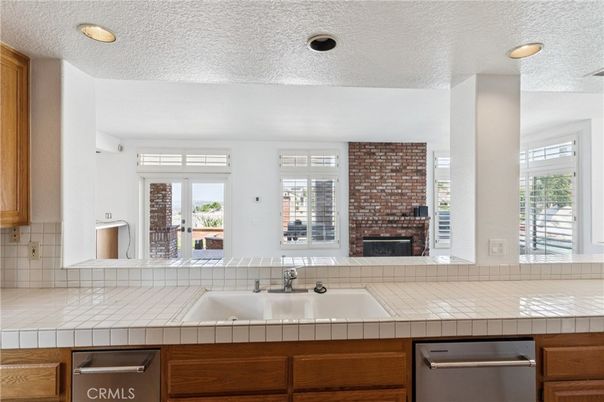 Fireplace, Interior, Kitchen, Recessed Lighting, Stainless Steel Appliances, Stone Walls, Tile Countertops