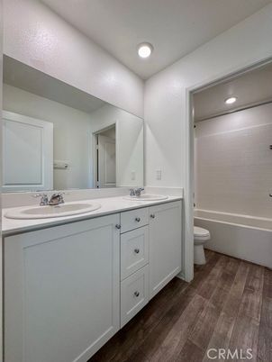 Bathroom, Dual Sink Vanities, Interior, Recessed Lighting, Wood Texture Flooring