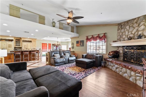 Chandelier, Fireplace, Interior, Kitchen, Living room, Recessed Lighting, Stone Walls, Wood Texture Flooring