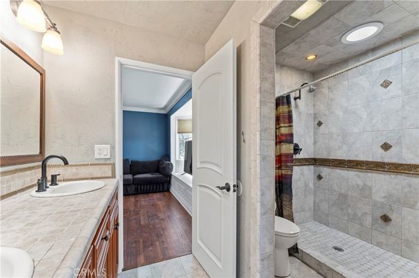 Bathroom, Glass Shower, Interior, Recessed Lighting, Tile Countertops, Wood Texture Flooring