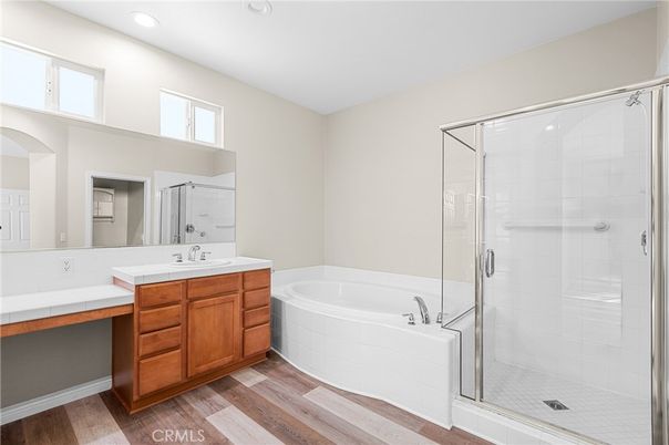 Bathroom, Dual Sink Vanities, Glass Shower, Interior, Recessed Lighting, Wood Texture Flooring