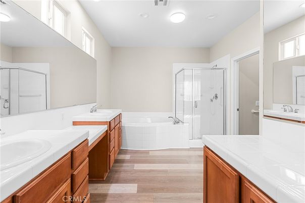 Bathroom, Dual Sink Vanities, Glass Shower, Interior, Recessed Lighting, Tile Countertops, Wood Texture Flooring
