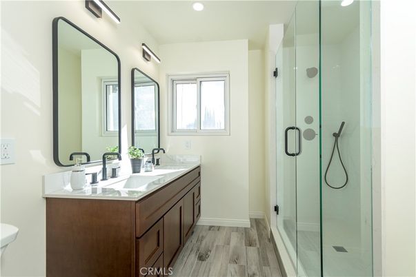 Bathroom, Dual Sink Vanities, Glass Shower, Interior, Recessed Lighting, Wood Texture Flooring