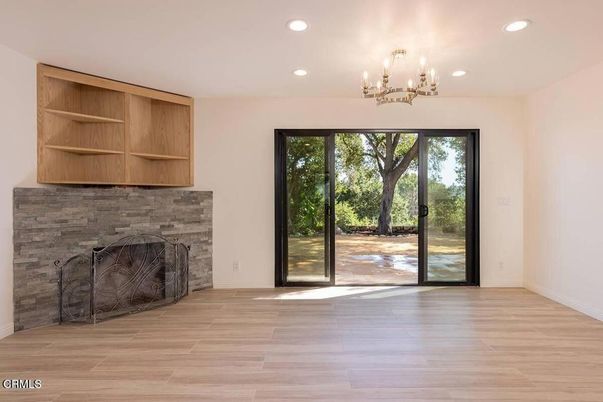 Chandelier, Empty room, Fireplace, Interior, Recessed Lighting, Wood Texture Flooring