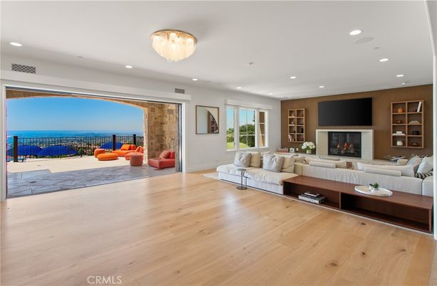 Chandelier, Fireplace, Interior, Living room, Recessed Lighting, Water, Wood Texture Flooring