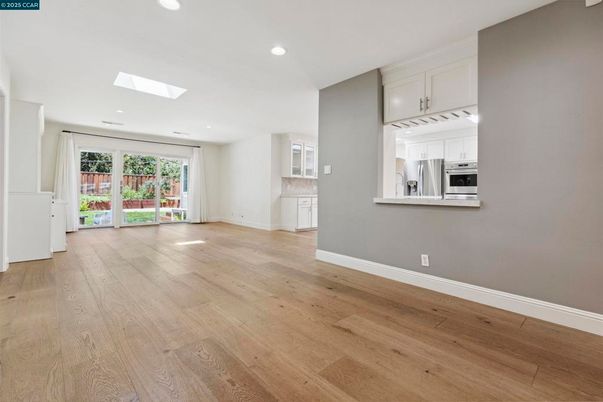 Empty room, Interior, Kitchen, Recessed Lighting, Stainless Steel Appliances, Wood Texture Flooring