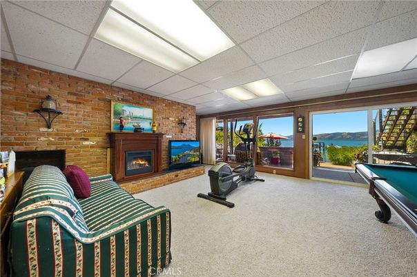 Billiard Table, Fireplace, Fitness Equipment, Game Room, Interior, Recessed Lighting, Stone Walls, Water