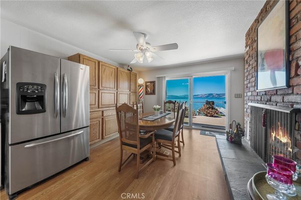 Dining room, Fireplace, Interior, Kitchen, Stainless Steel Appliances, Stone Walls, Water, Wood Texture Flooring