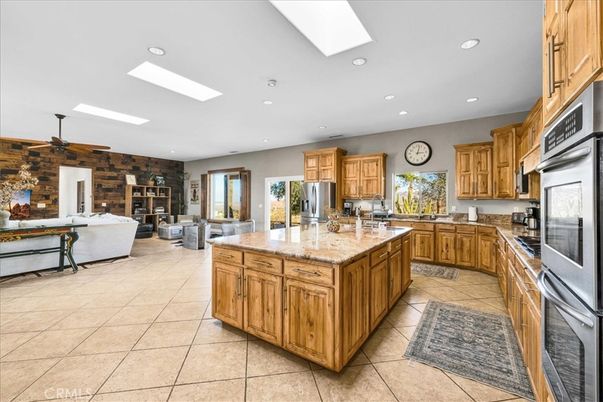 Fireplace, Interior, Kitchen, Living room, Recessed Lighting, Stainless Steel Appliances, Stone Walls