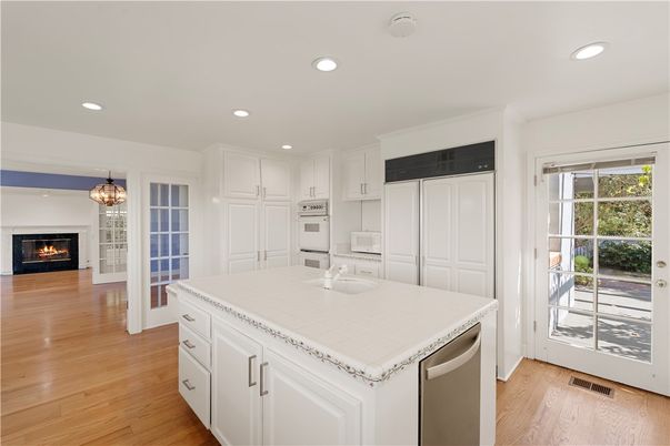 Fireplace, Interior, Kitchen, Pendant Lights, Recessed Lighting, Stainless Steel Appliances, Tile Countertops, Wood Texture Flooring