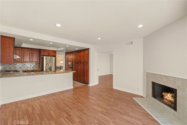 Fireplace, Interior, Kitchen, Recessed Lighting, Stainless Steel Appliances, Wood Texture Flooring