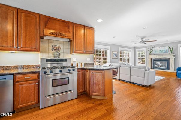 Fireplace, Interior, Kitchen, Living room, Recessed Lighting, Stainless Steel Appliances, Wood Texture Flooring