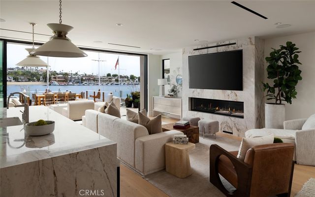 Dining room, Fireplace, Interior, Living room, Pendant Lights, Recessed Lighting, Water, Wood Texture Flooring