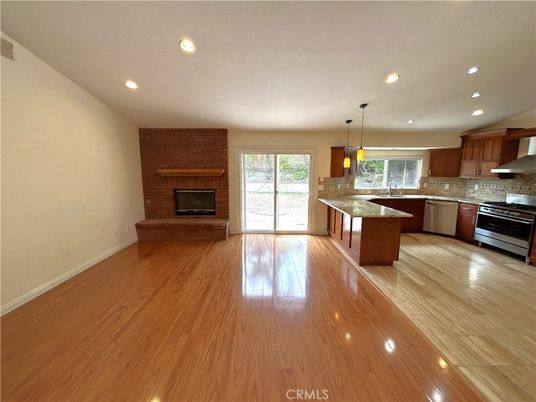 Empty room, Fireplace, Interior, Kitchen, Pendant Lights, Recessed Lighting, Stone Walls, Wood Texture Flooring