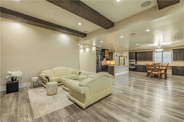Chandelier, Dining room, Interior, Kitchen, Living room, Pendant Lights, Recessed Lighting, Stainless Steel Appliances, Wooden Beams, Wood Texture Flooring