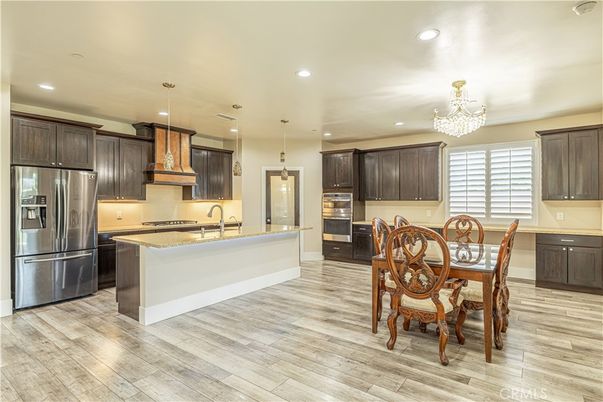 Chandelier, Dining room, Interior, Kitchen, Pendant Lights, Recessed Lighting, Stainless Steel Appliances, Wood Texture Flooring