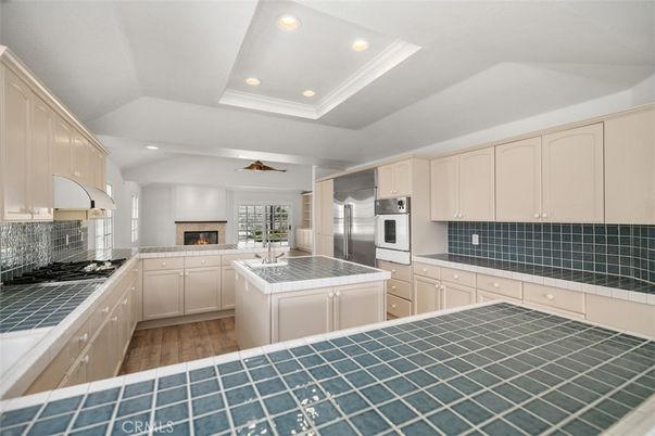 Interior, Kitchen, Recessed Lighting, Stainless Steel Appliances, Tile Countertops, Wood Texture Flooring