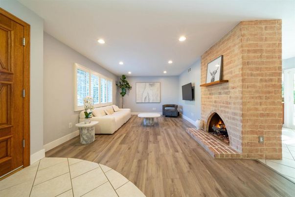 Fireplace, Interior, Living room, Recessed Lighting, Stone Walls, Wood Texture Flooring