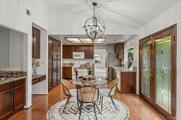 Chandelier, Dining room, Interior, Kitchen, Pendant Lights, Recessed Lighting, Stainless Steel Appliances, Wood Texture Flooring