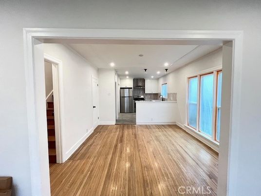 Empty room, Interior, Kitchen, Recessed Lighting, Stainless Steel Appliances, Wood Texture Flooring