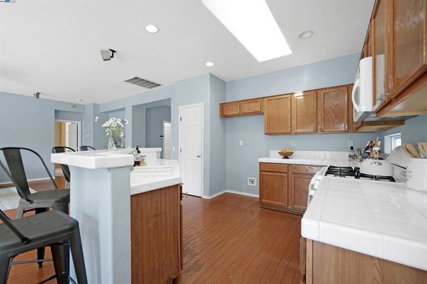 Interior, Kitchen, Recessed Lighting, Tile Countertops, Wood Texture Flooring