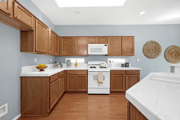 Interior, Kitchen, Recessed Lighting, Tile Countertops, Wood Texture Flooring