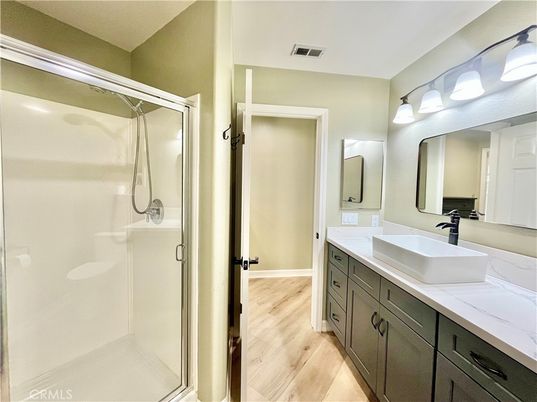 Bathroom, Dual Sink Vanities, Glass Shower, Interior, Tile Countertops, Wood Texture Flooring