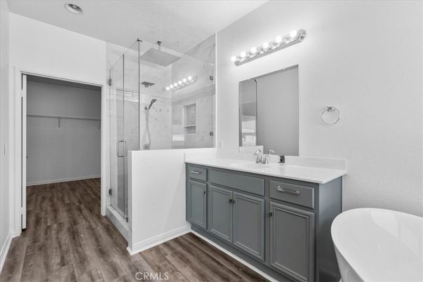 Bathroom, Dual Sink Vanities, Free Standing Baths, Glass Shower, Interior, Marble Walls, Recessed Lighting, Wood Texture Flooring