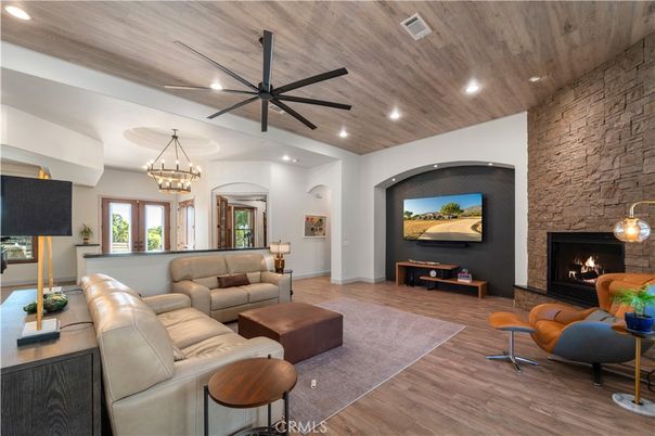 Chandelier, Fireplace, Interior, Living room, Recessed Lighting, Stone Walls, Wooden Ceilings, Wood Texture Flooring