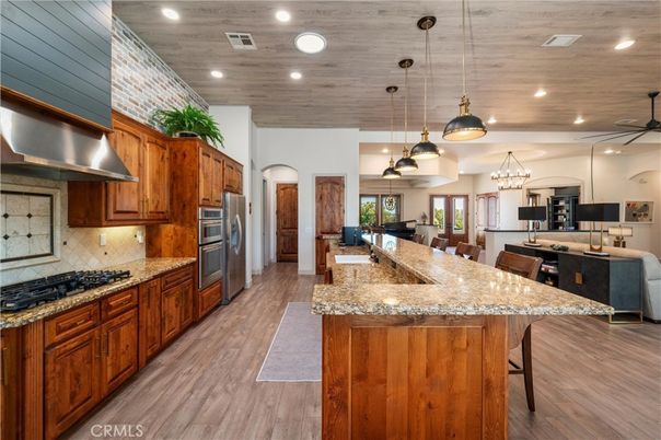 Chandelier, Dining room, Interior, Kitchen, Pendant Lights, Recessed Lighting, Stainless Steel Appliances, Wooden Ceilings, Wood Texture Flooring