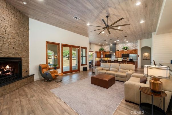 Fireplace, Interior, Kitchen, Living room, Pendant Lights, Recessed Lighting, Stainless Steel Appliances, Stone Walls, Wooden Ceilings, Wood Texture Flooring