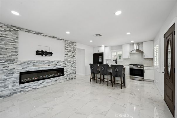 Fireplace, Interior, Kitchen, Marble, Recessed Lighting, Stainless Steel Appliances, Stone Walls