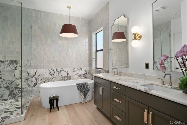 Bathroom, Dual Sink Vanities, Free Standing Baths, Glass Shower, Interior, Marble Walls, Pendant Lights, Wood Texture Flooring