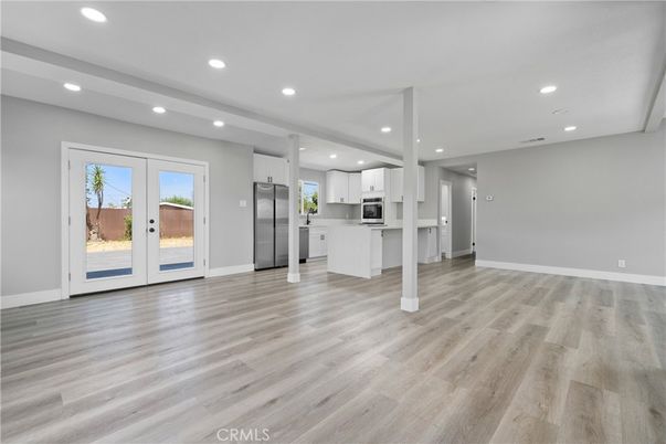 Empty room, Interior, Kitchen, Recessed Lighting, Stainless Steel Appliances, Wood Texture Flooring