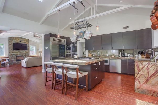 Fireplace, Interior, Kitchen, Living room, Pendant Lights, Recessed Lighting, Stainless Steel Appliances, Stone Walls, Wood Texture Flooring