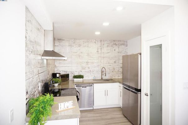 Interior, Kitchen, Marble Walls, Recessed Lighting, Stainless Steel Appliances, Stone Walls, Wood Texture Flooring